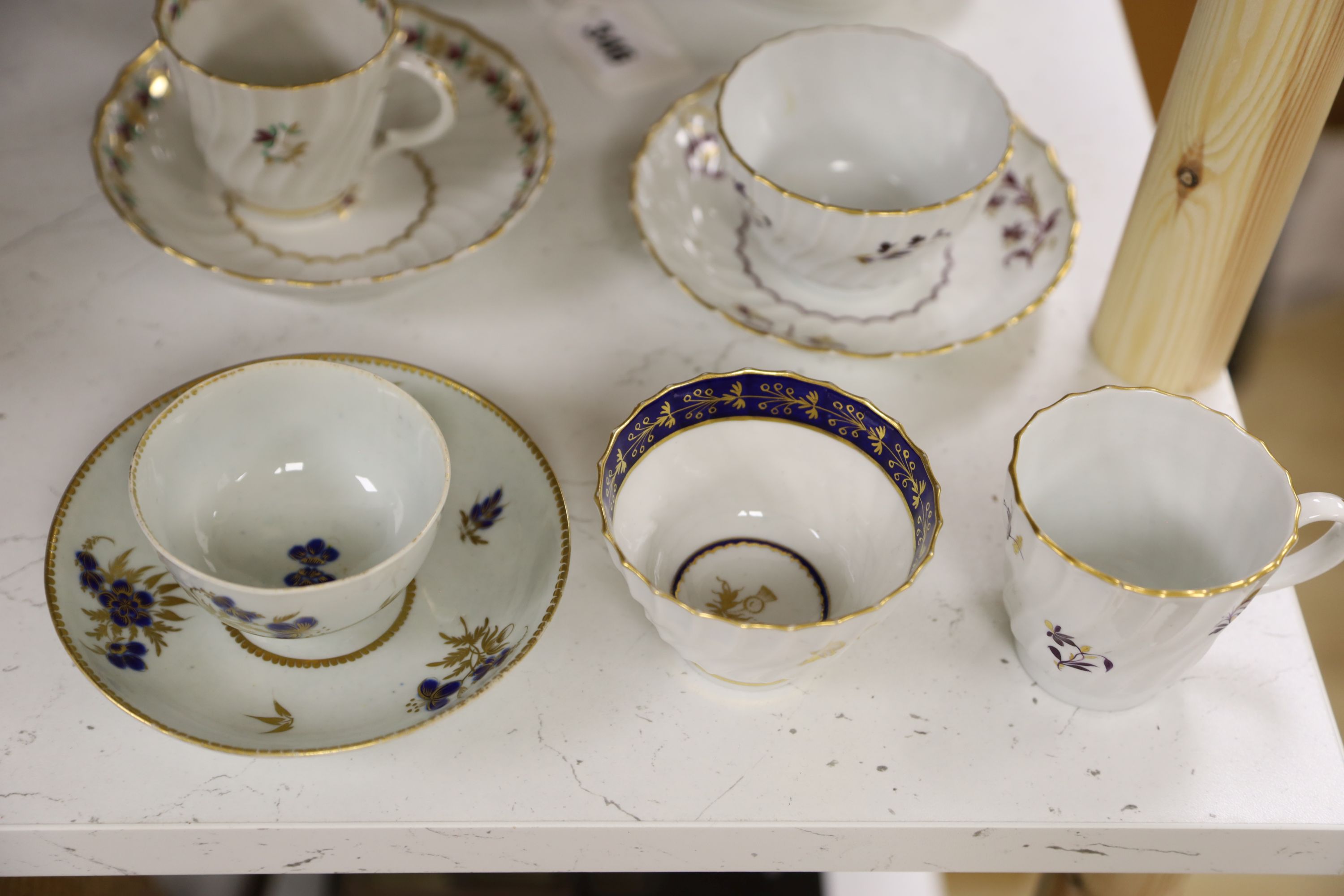 Two Flight trios, two teabowls and saucers and a coffee cup and saucer